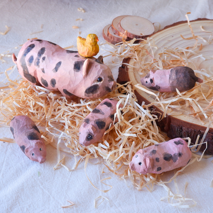 Hand-carved wooden Snuggle Pigs set arranged on wood shavings - pig gift and nature-inspired home decor by anornament