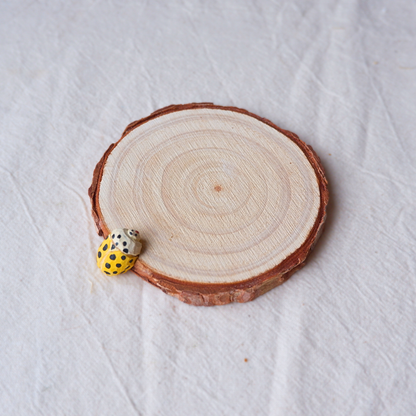 Yellow ladybird coaster hand-carved from linden wood, nature-inspired home decor