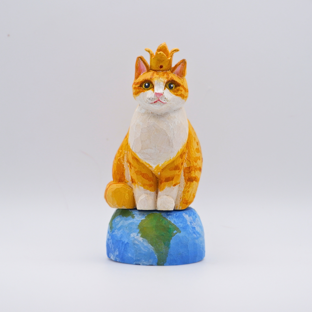 Hand-carved wooden Ginger cat figurine with gold crown seated on painted Earth globe base by anornament