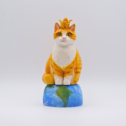Hand-carved wooden Ginger cat figurine with gold crown seated on painted Earth globe base by anornament