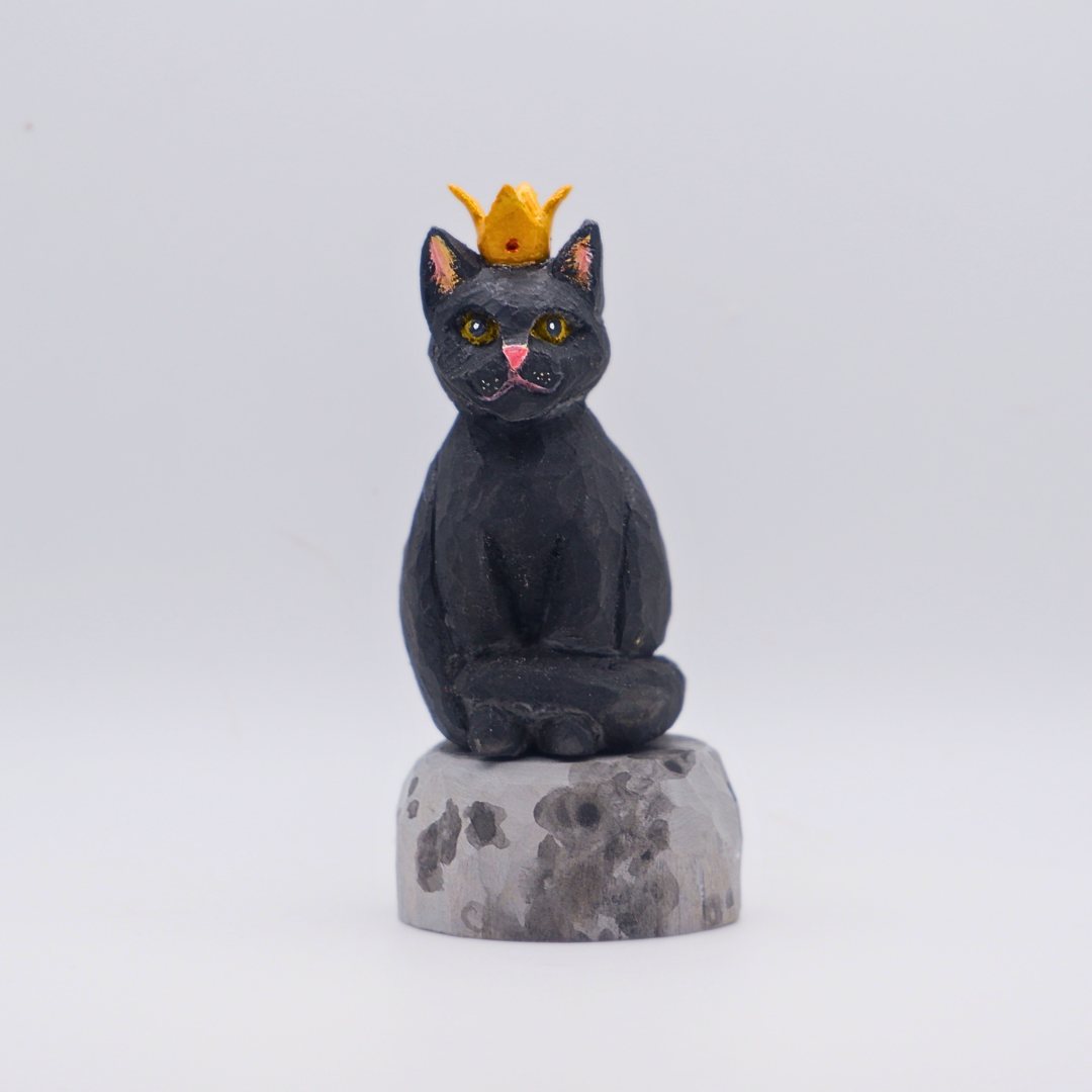 Hand-carved wooden black cat figurine with gold crown seated on painted Moon base by anornament