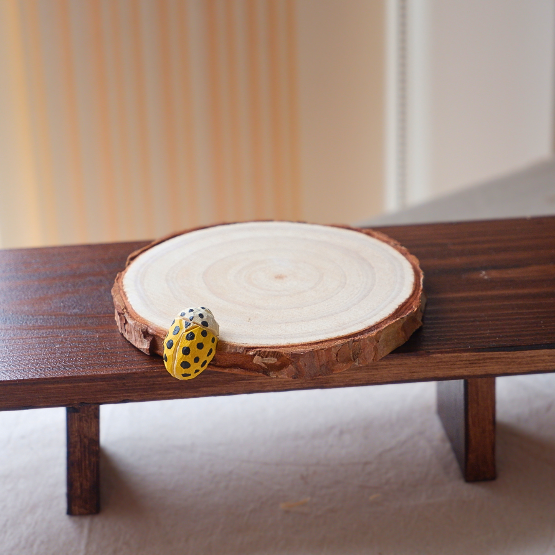 Yellow ladybird coaster hand-carved from linden wood, nature-inspired home decor