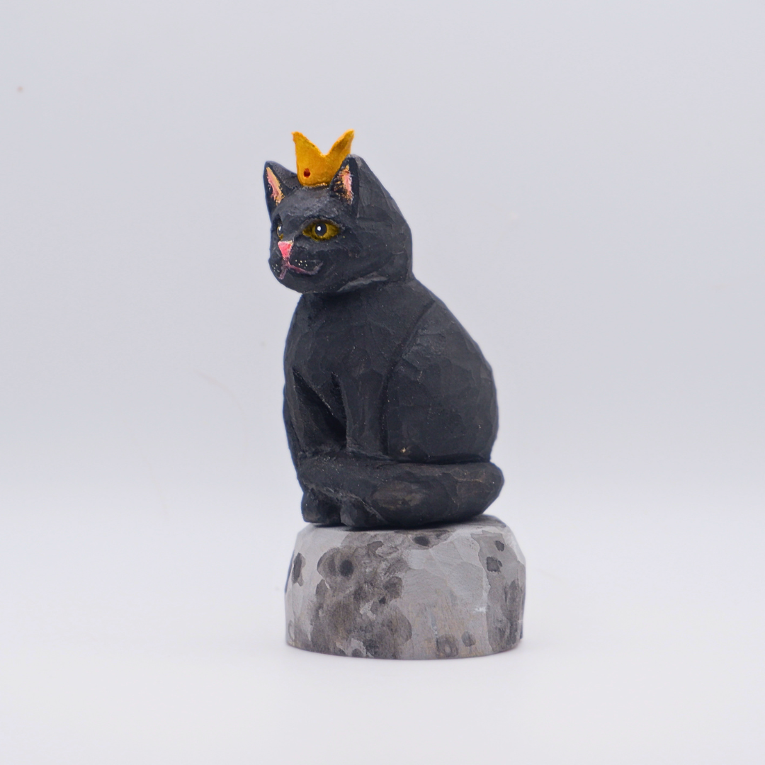Hand-carved wooden black cat figurine with gold crown seated on painted Moon base by anornament